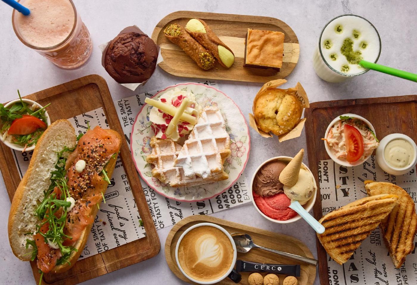 Een tafel vol lunch, wafel, cannoli, ijs, koffie en smoothies van Gemelli